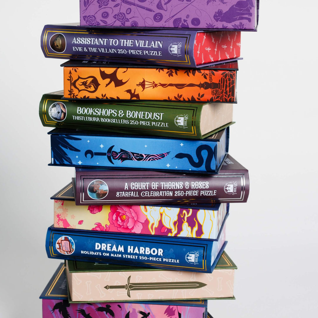 Stack of puzzle boxes shapes like books. The sides look like book spines and sprayed edges.