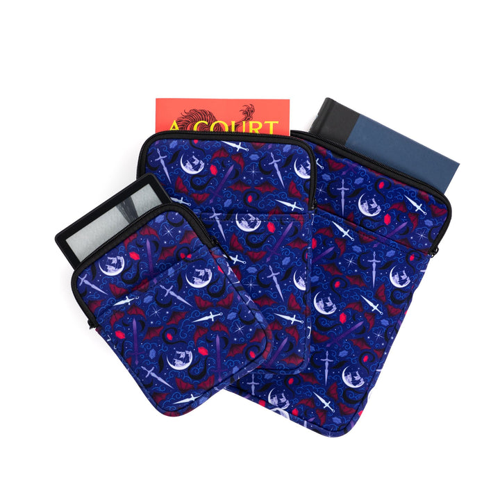 3 book sleeves sizes fanned out, e-reader, medium, and large with a pattern of Mt. Ramiel, swords, daggers, runes, and bat wings, from ACOTAR by Sarah J Maas.