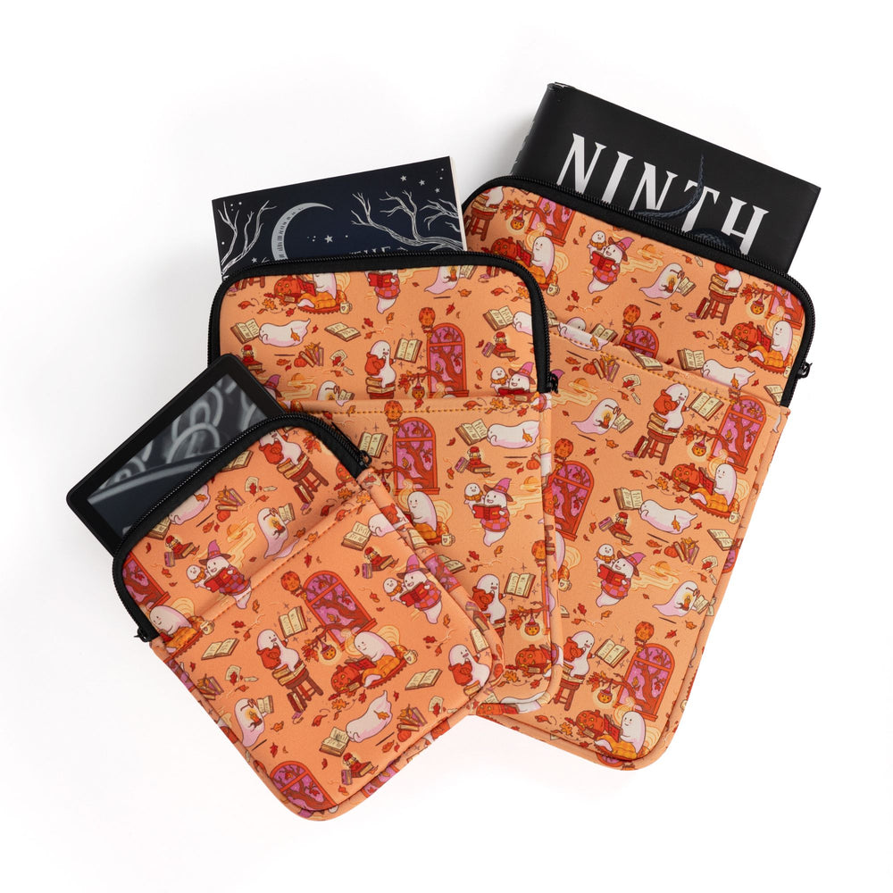 Three sizes of zippered booksleeves with orange background and ghosts reading books. A book sticks out of each.