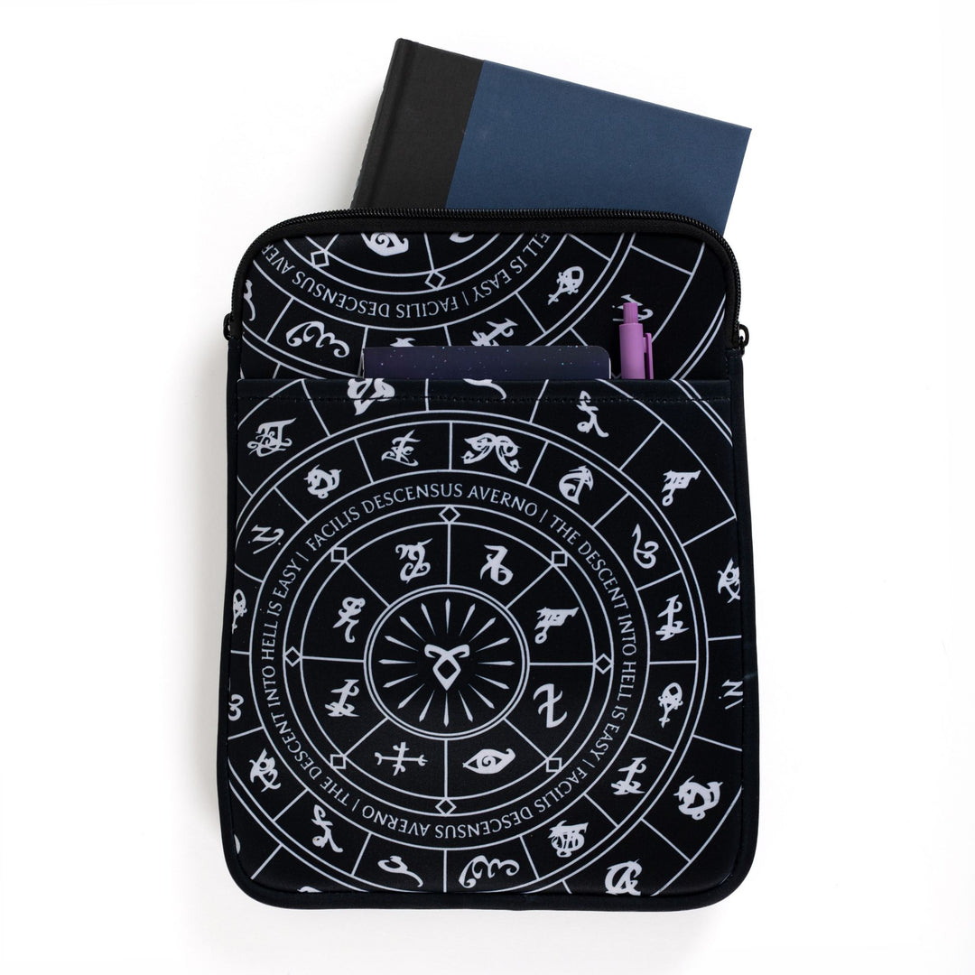 Large zippered booksleeve with black background and white Shadowhunters runes. A hardcover is sticking out. 
