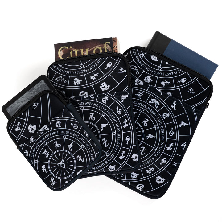 Three sizes of zippered booksleeves with black background and white Shadowhunters runes. A book sticks out of each.
