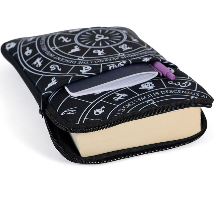 Medium zippered booksleeve with black background and white Shadowhunters runes, laying flat with a paperback book sticking out. 
