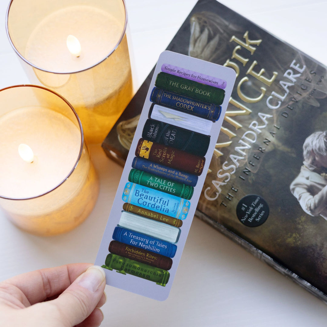 Bookmark of a stack of in-world Shadowhunters books, held over Clockwork Prince.
