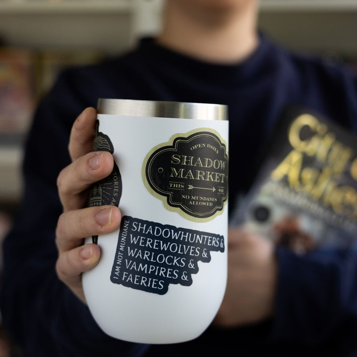  Sticker on a white tumbler that reads ‘I am not mundane. Shadowhunters, and werewolves, and warlocks, and vampires, and faeries.’

