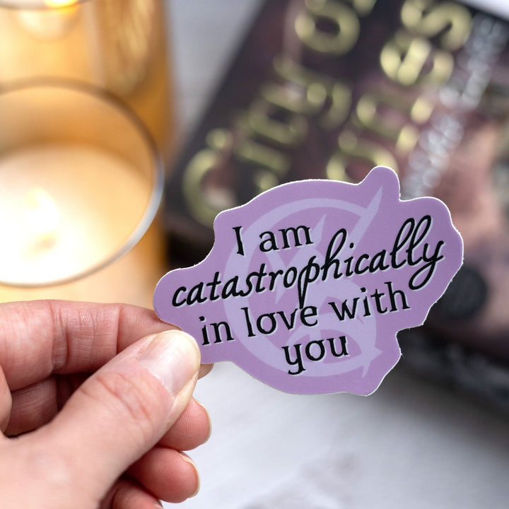 Shadowhunters quote sticker: ‘I am catastrophically in love with you’ over a wedded union rune. Held over City of Bones.