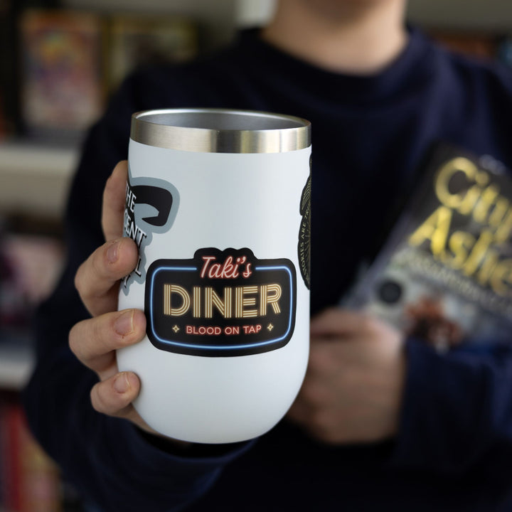 Shadowhunter’s sticker reads: ‘Taki’s Diner, blood on tap’ in the style of a neon sign, on a white tumbler.