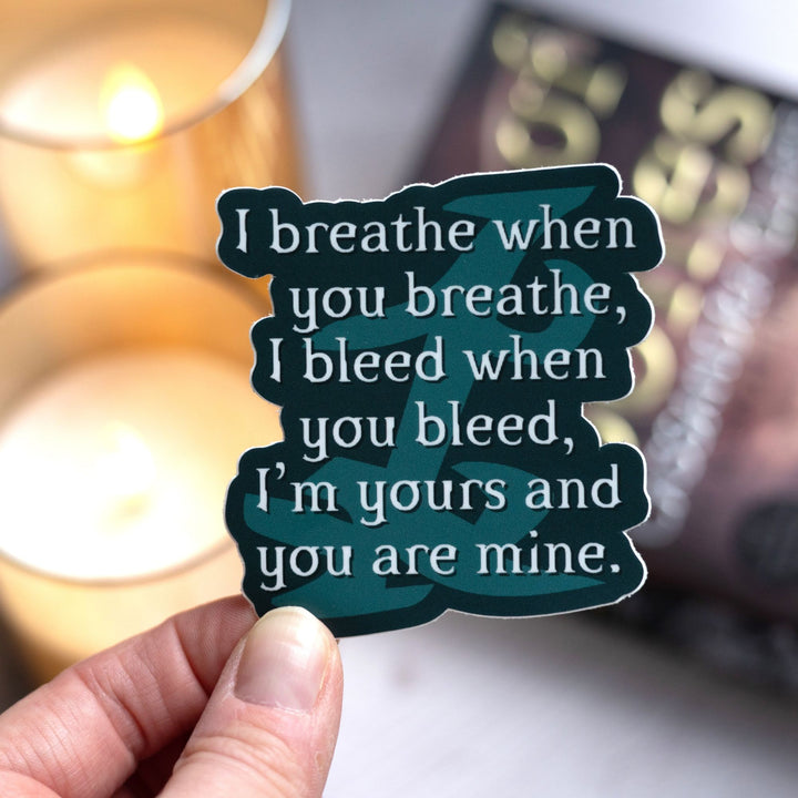  Shadowhunters quote sticker reads: ‘I breathe when you breathe, I bleed when you bleed, I’m yours and you are mine,’ with parabatai rune, held over City of Bones.
