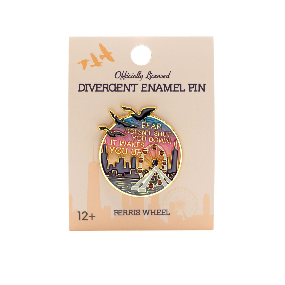 Enamel pin of the Navy Pier Ferris wheel at sunset with the Divergent quote ‘Fear doesn’t shut you down, it wakes you up.’ in gold metal on a tan backer card.