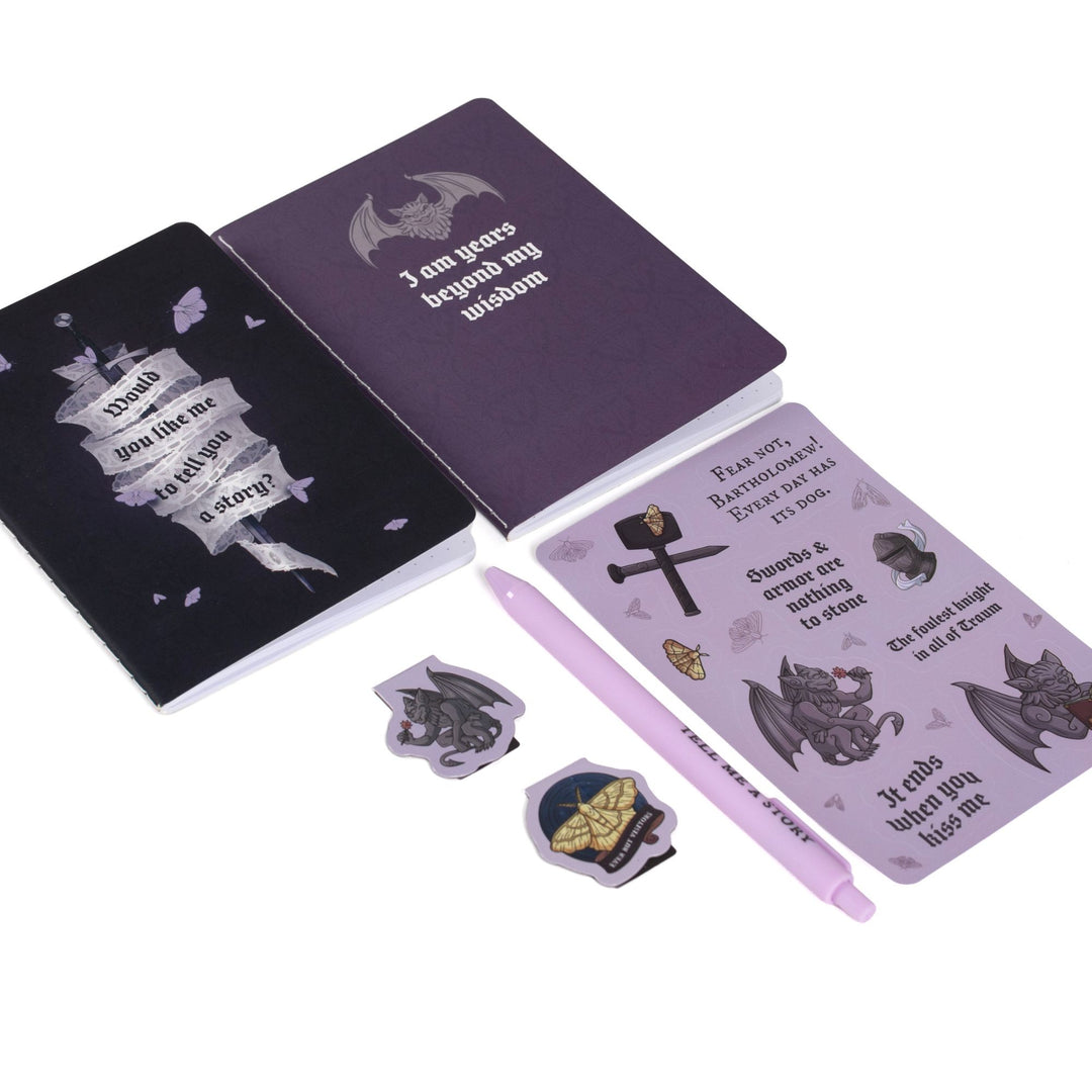 Gift set laid out: A6 ‘I am years beyond my wisdom’ and sword on dark purple journals, Knight and the Moth sticker sheet,  ‘Ever But Visitors’ & Bartholomew magnetic bookmarks, purple pen.