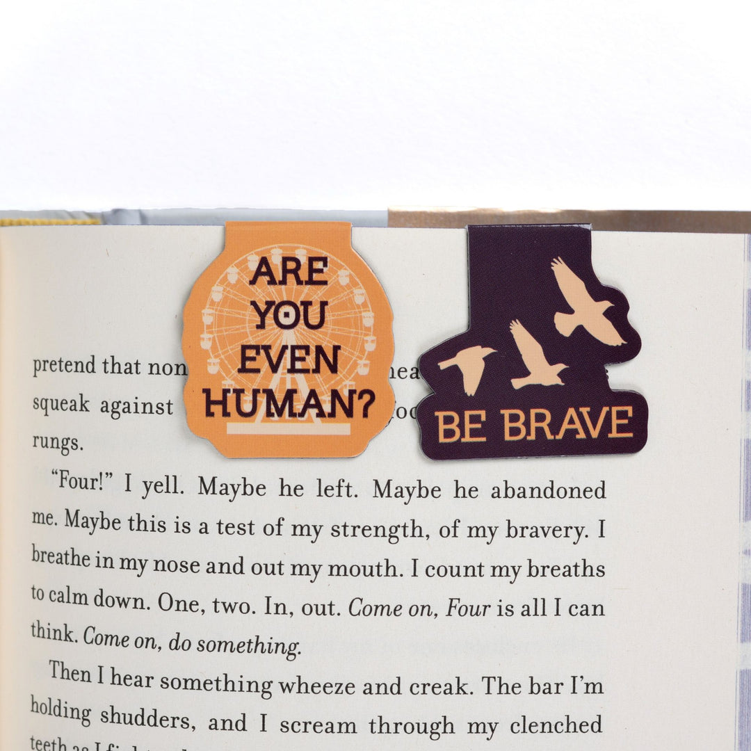 ‘Be brave’ & 'Are you even human?' magnetic bookmarks on open book. Quotes from Divergent.