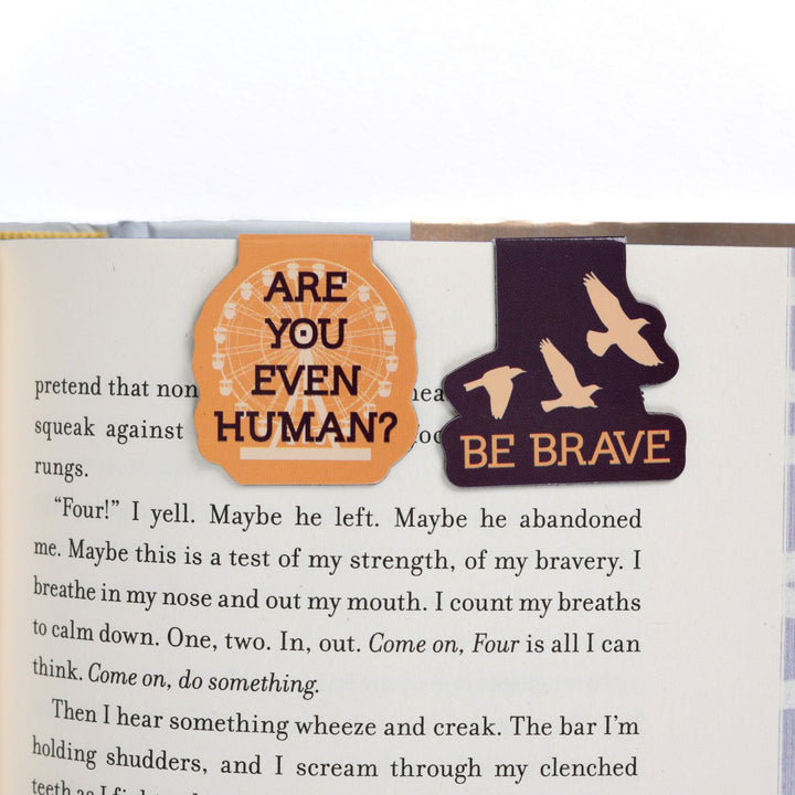 ‘Be brave’ & 'Are you even human?' magnetic bookmarks on open book. Quotes from Divergent.