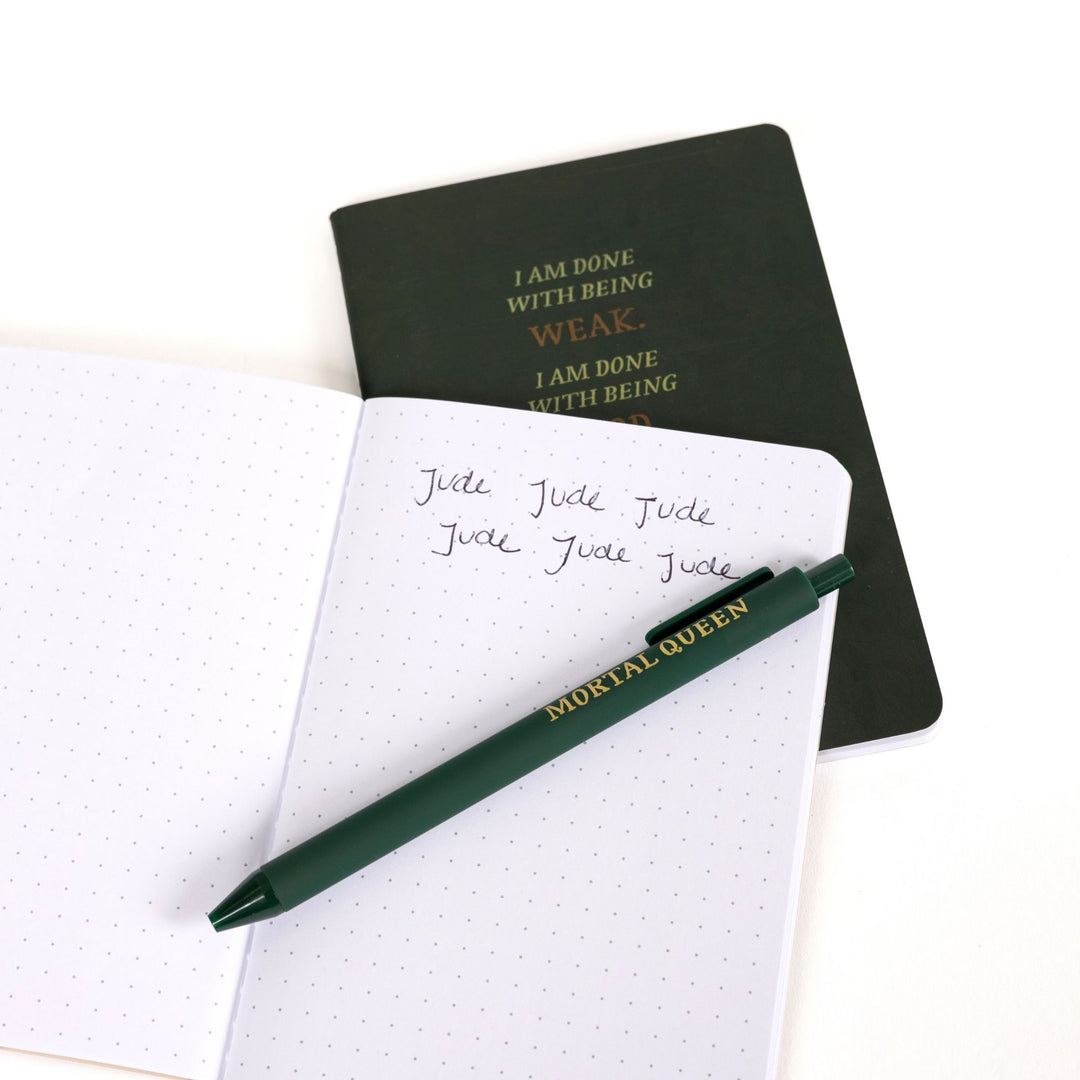 Green ‘I am done being weak’ A6 journal behind an open A6 dot grid journal with green pen and handwritten note: ‘Jude,Jude,Jude,Jude,Jude,Jude.’