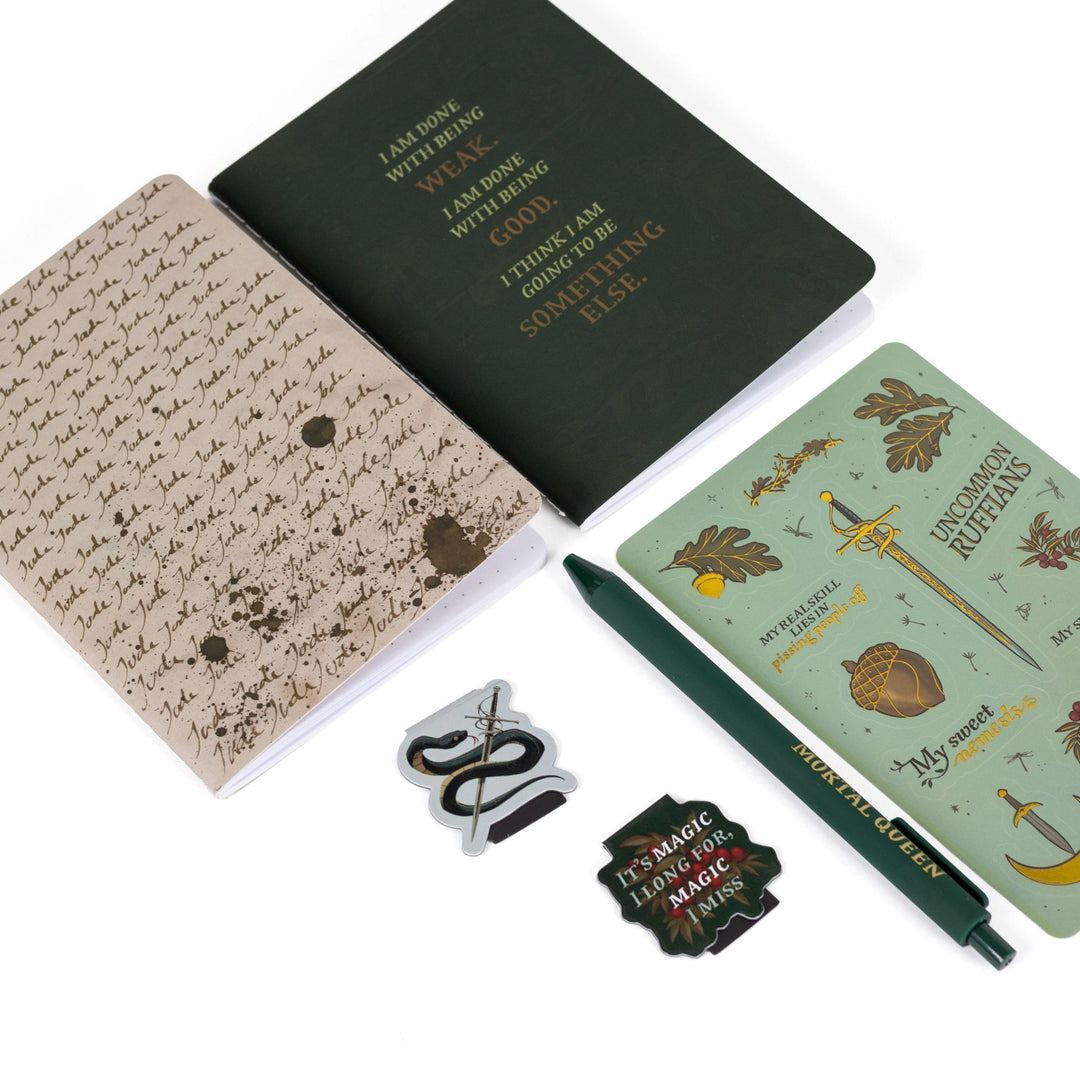 Gift set laid out: A6 ‘Jude Jude Jude’ and green ‘I am done being weak’ journals, The Cruel Prince sticker sheet, Serpent King Cardan & 'It’s magic I long for, magic I miss’ magnetic bookmarks green pen.
