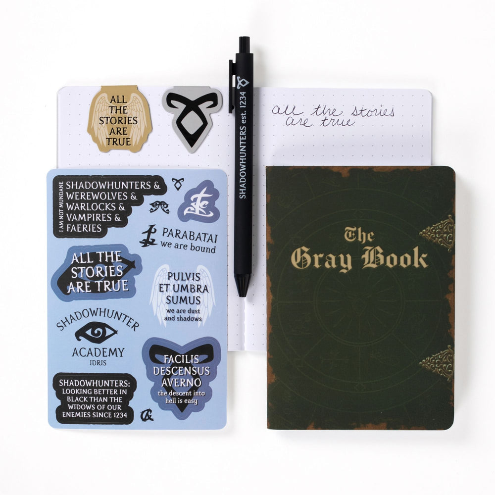 Gift set opened: Dot grid A6 journal open with pen, ‘All the stories are true’ & Enkeli rune magnetic bookmarks, Shadowhunters sticker sheet, A6 Shadowhunters codex and The Gray book journal.