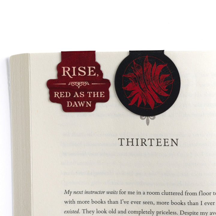 ‘Rise, Red as the Dawn’ and the Scarlet Guard magnetic bookmarks on open book. Quote and symbol from Red Queen.
