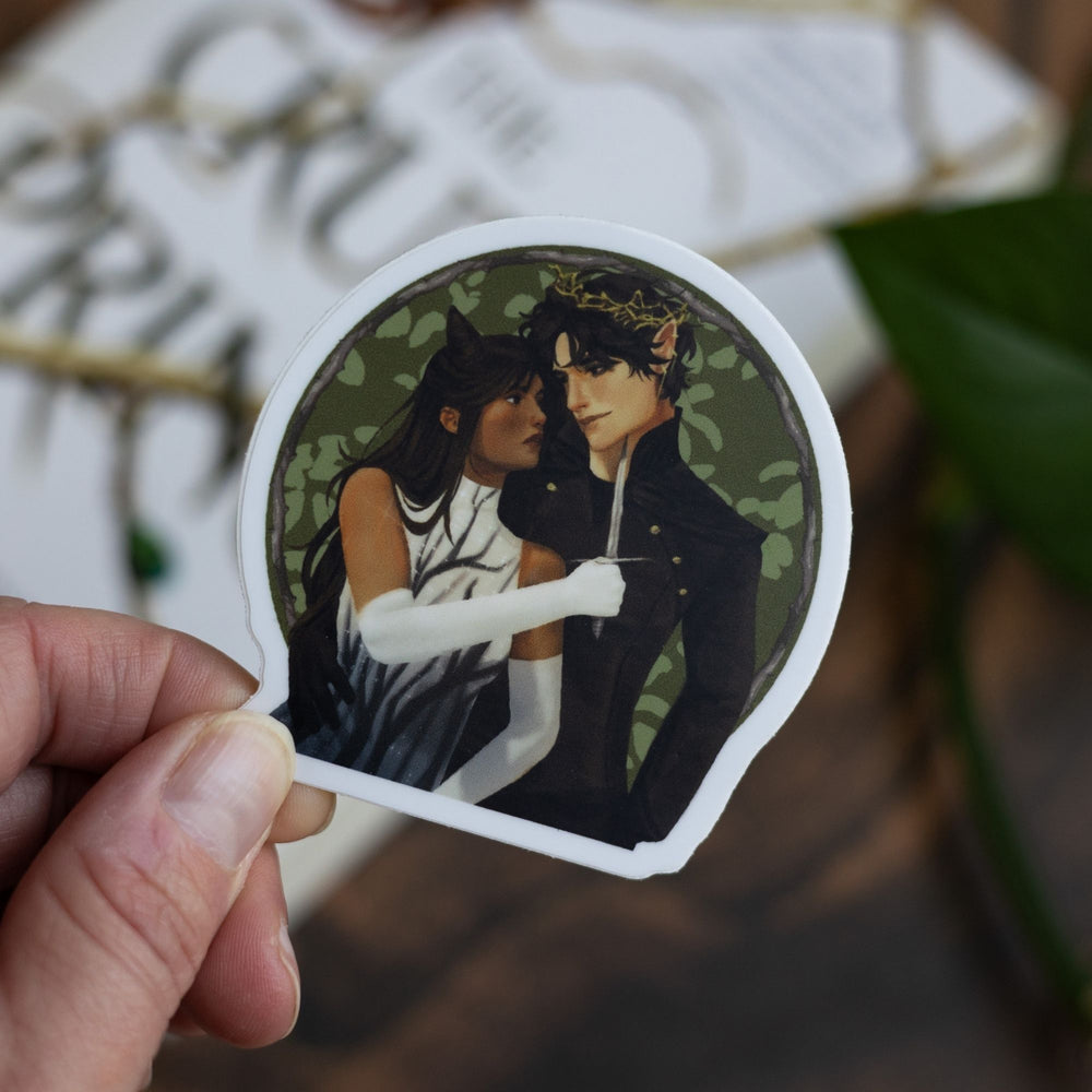 Sticker of Jude holding a knife to Cardan over a green background, held above The Cruel Prince.
