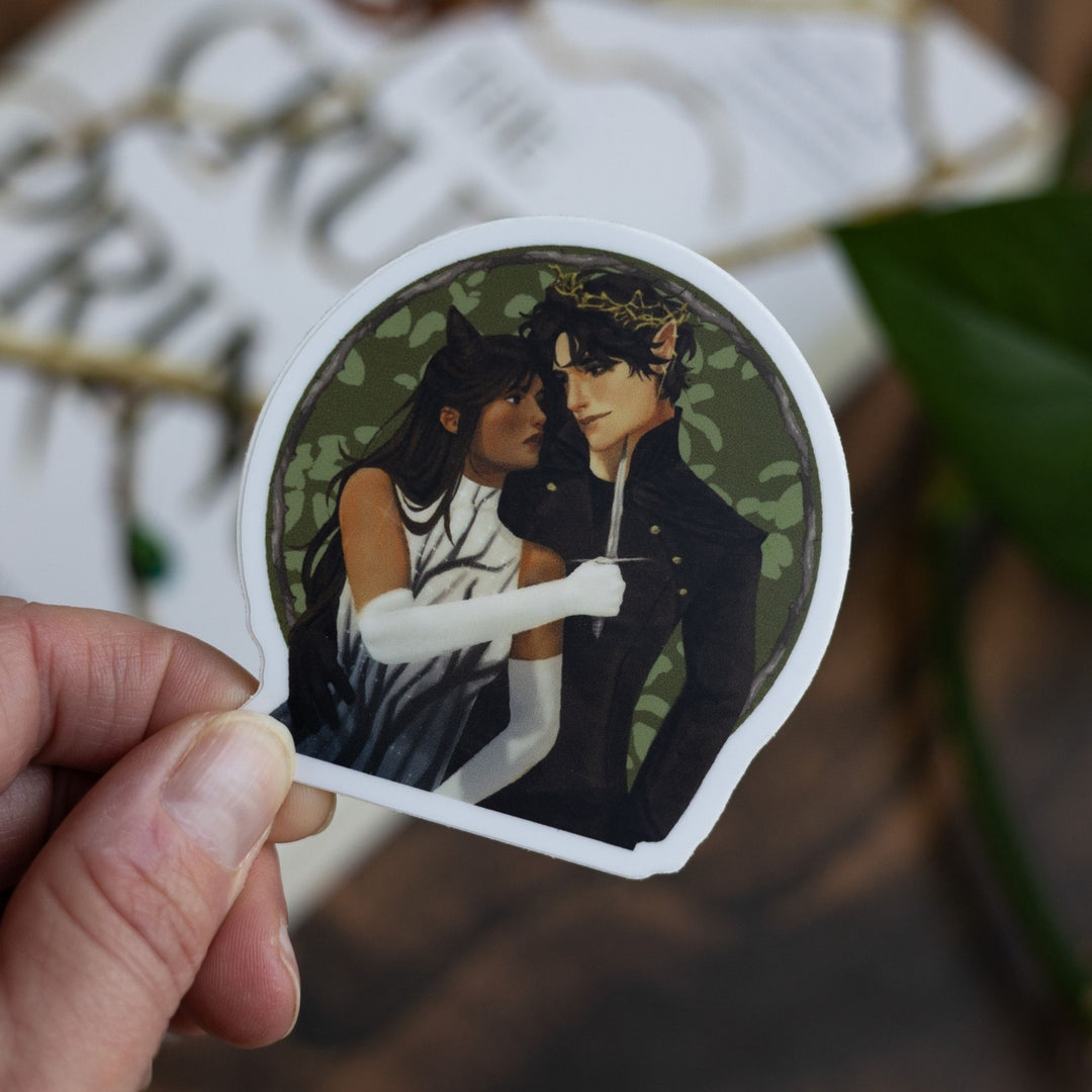 Sticker of Jude holding a knife to Cardan over a green background, held above The Cruel Prince.