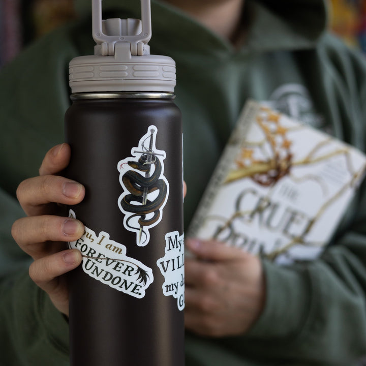 Sticker on a black water bottle of Cardan in serpent form, wrapped around the sword Nightfell.  from The Cruel Prince.