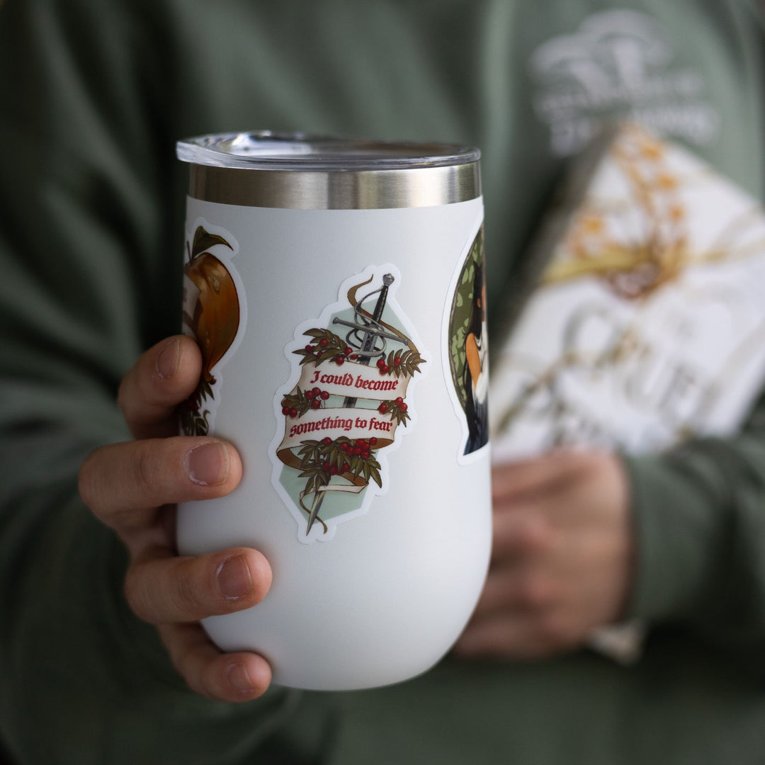 Sticker of the sword Nightfell with a banner ‘I could become something to fear’ and rowan berries on a white cup.