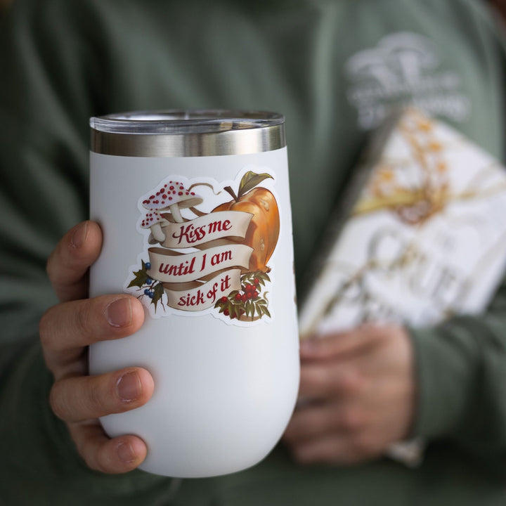 Cruel Prince quote sticker on white tumbler: ‘Kiss me until I am sick of it’ with rowan berries, blusher mushrooms, and faerie fruit. 