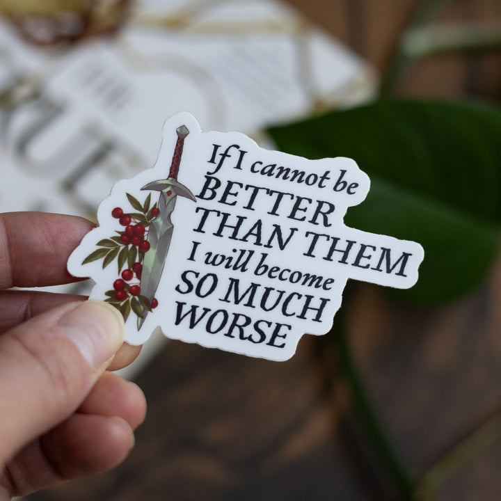 Cruel Prince quote sticker: ‘If I cannot be better than them I will become so much worse’ with a dagger. Held above The Cruel Prince.
