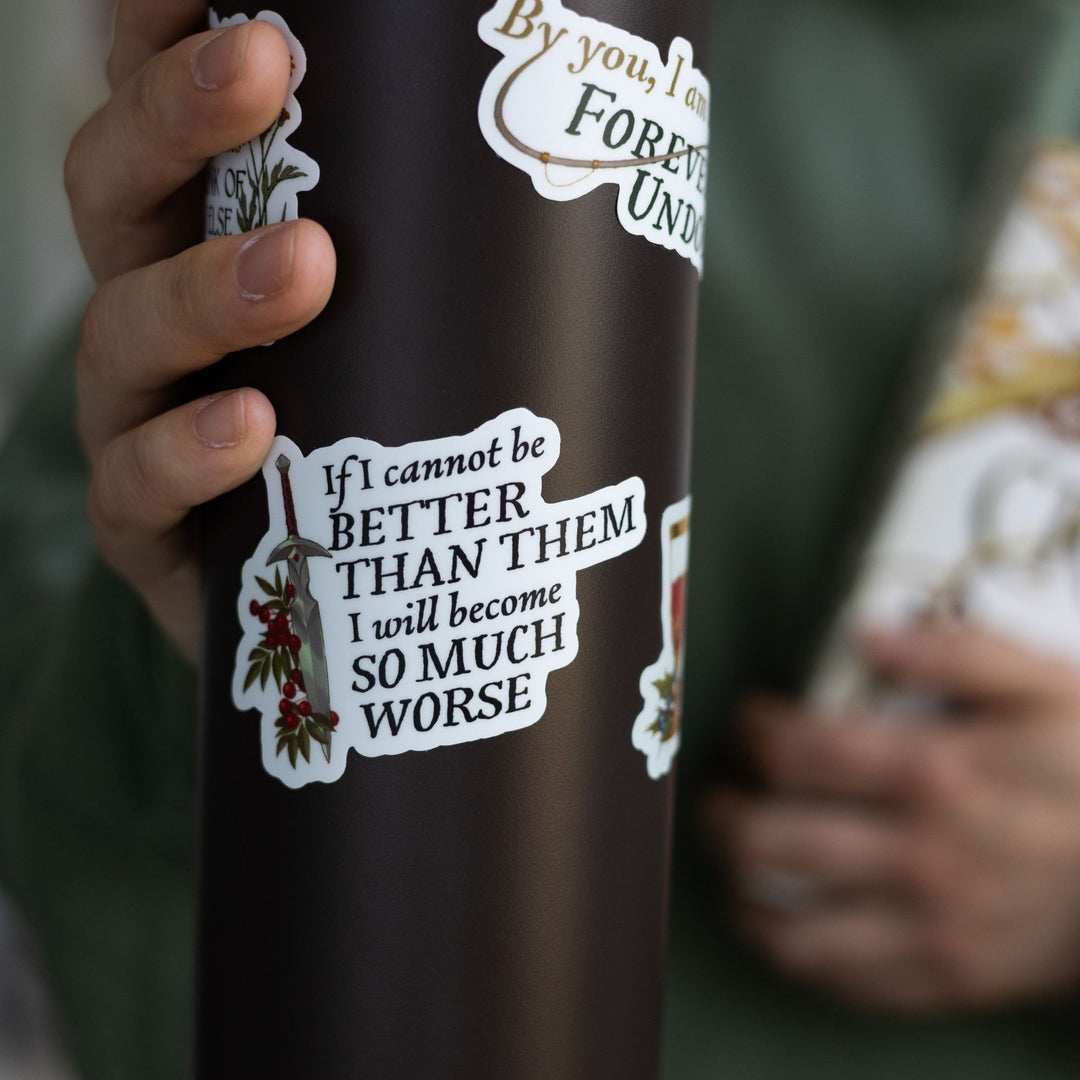 Cruel Prince quote sticker on black water bottle: ‘If I cannot be better than them I will become so much worse’ with a dagger. 