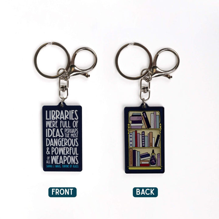 2 dark blue acrylic keychains. 'Libraries were full of ideas, perhaps the most dangerous and powerful weapons of them all’ on one and a full bookshelf on the other.