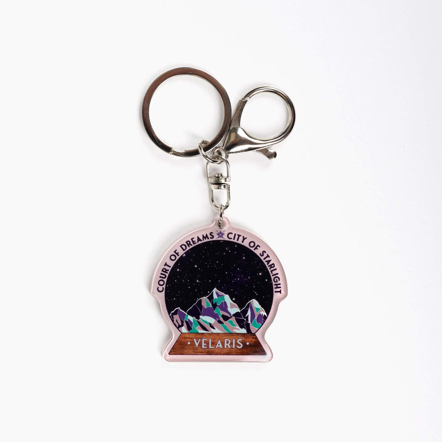  Acrylic keychain of snow globe with mountains against the night sky. 'Court of Dreams City of Starlight' above it. ‘Velaris’ on the base.
