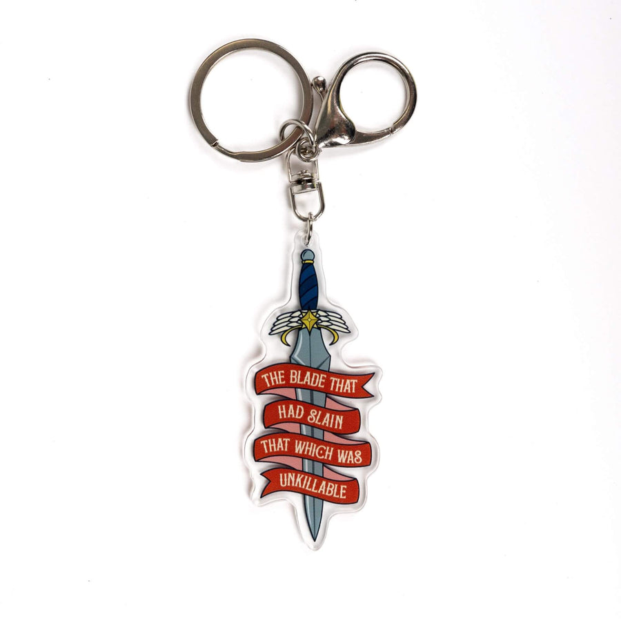 Acrylic keychain of a dagger. A red ribbon winds around it saying ‘The blade that had slain that which was unkillable.’