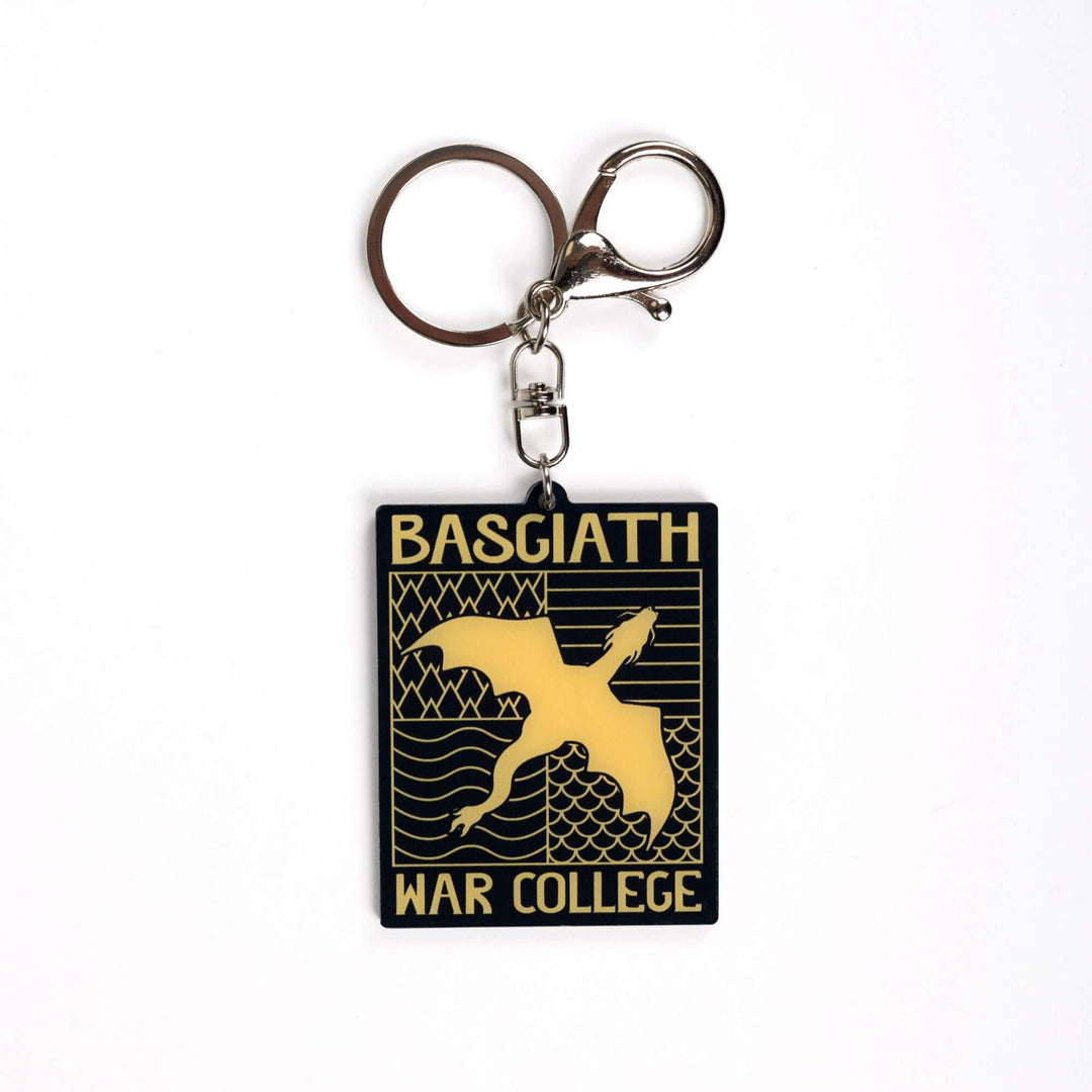 Acrylic keychain of black & gold Basgiath emblem, featuring a gold dragon flying over the quadrant symbols on a black background. From Fourth Wing