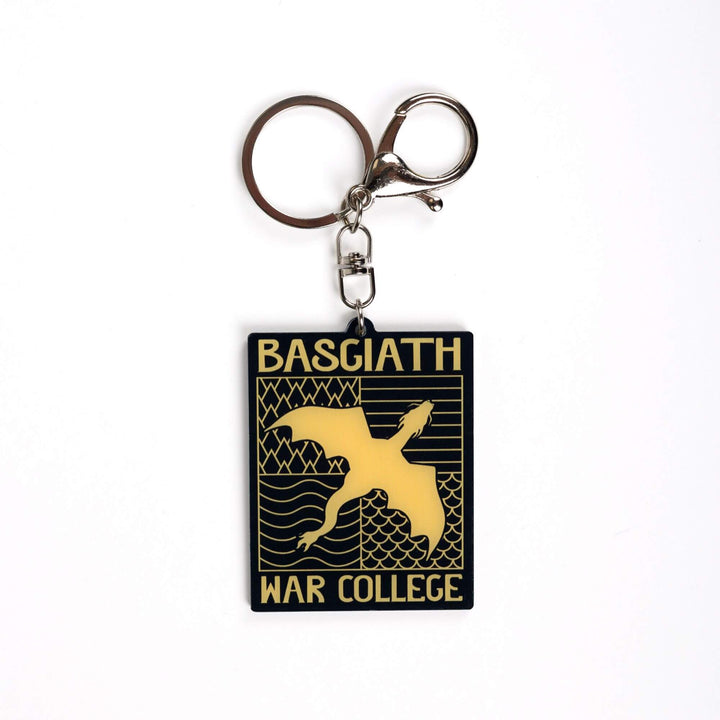 Acrylic keychain of black & gold Basgiath emblem, featuring a gold dragon flying over the quadrant symbols on a black background. From Fourth Wing
