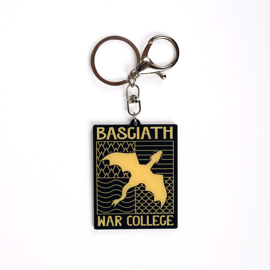 Acrylic keychain of black & gold Basgiath emblem, featuring a gold dragon flying over the quadrant symbols on a black background. From Fourth Wing