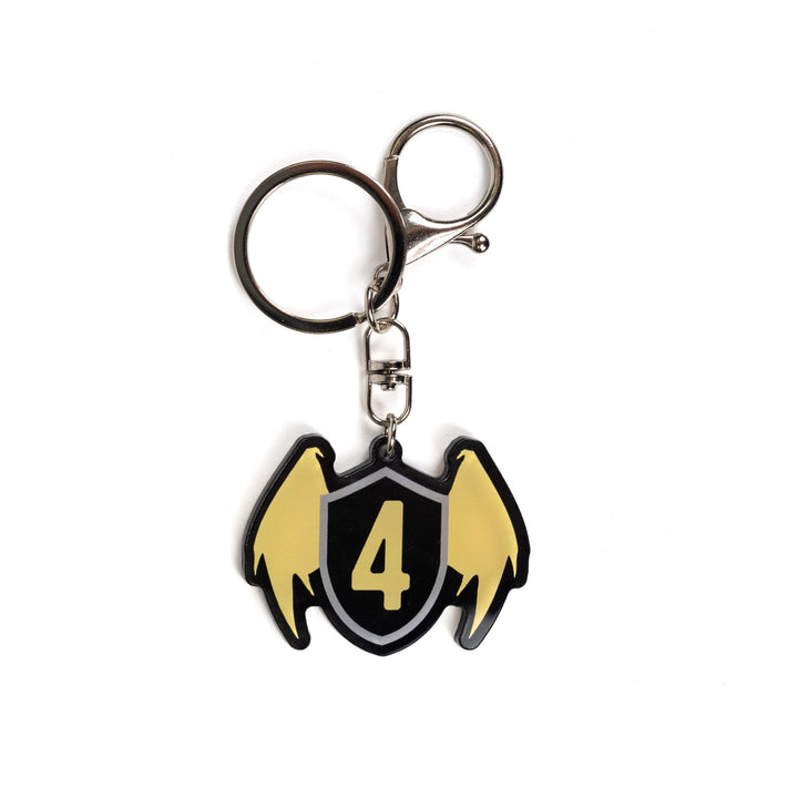  Acrylic keychain of a black shield with golden wings & a gold four on the shield. From Fourth Wing by Rebecca Yarros.