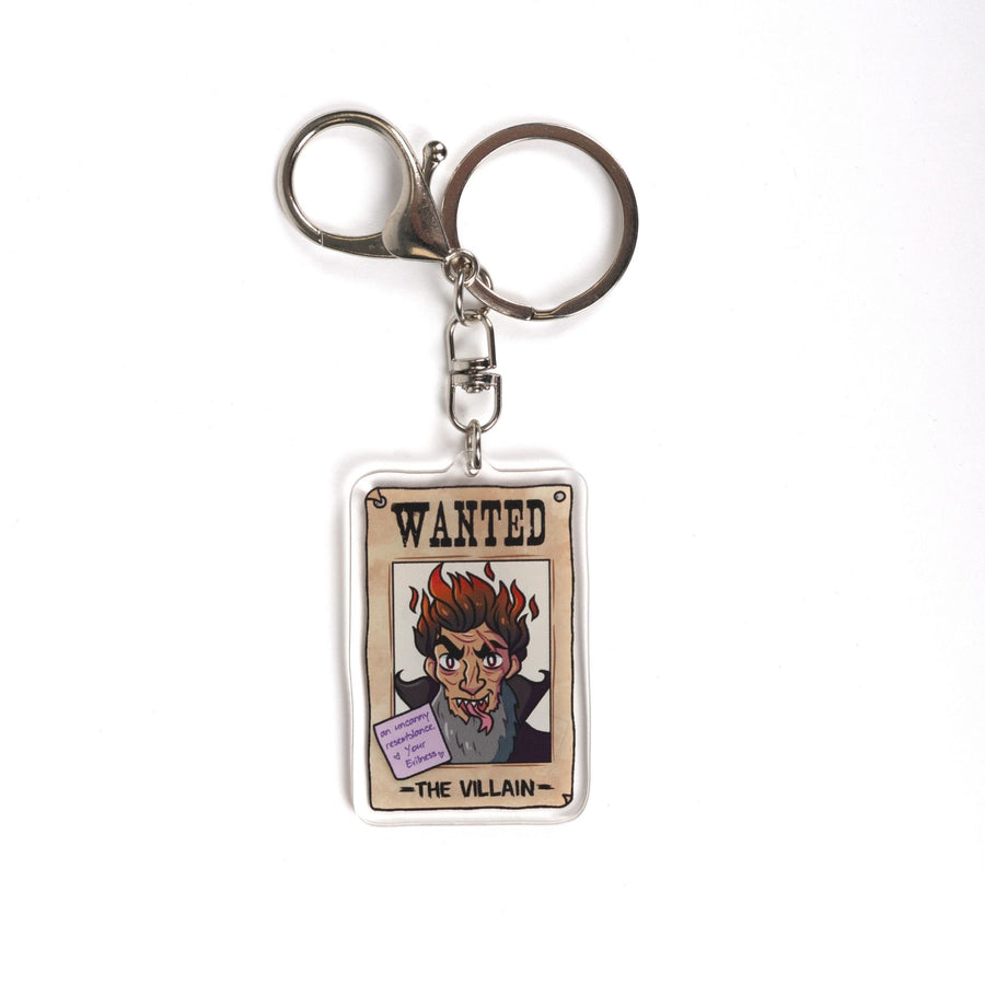  Acrylic keychain of a wanted poster of ‘ The Villain’ with a purple post-it note on it that reads ‘An Uncanny resemblance, Your evilness.’ 

