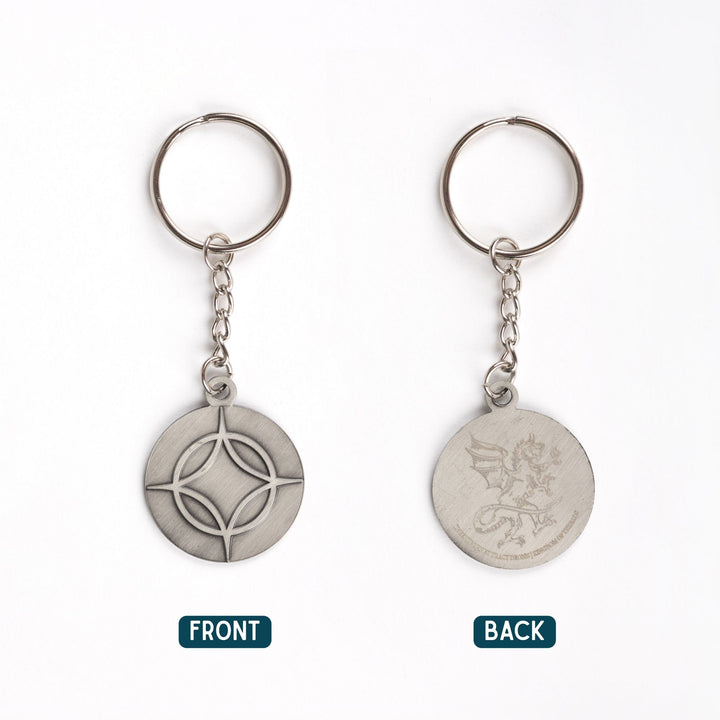 Metal keychain of a circle with a four point star over top. From Legendborn by Tracey Deonn. 
The backside has an etching of a dragon.
