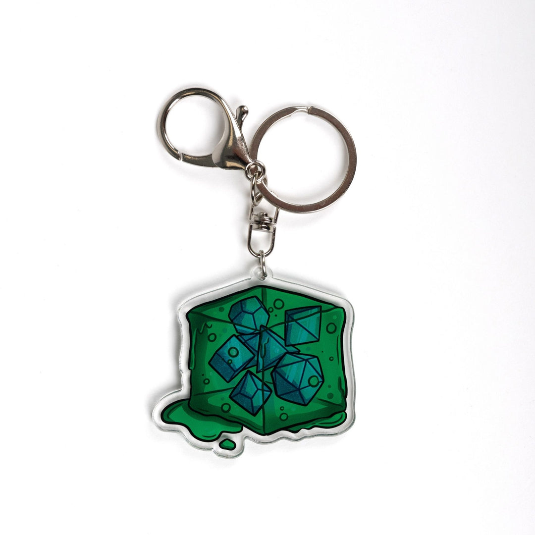  Acrylic keychain of a green gelatinous cube that is oozing and has DND dice inside of it. 
