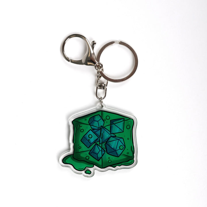  Acrylic keychain of a green gelatinous cube that is oozing and has DND dice inside of it. 
