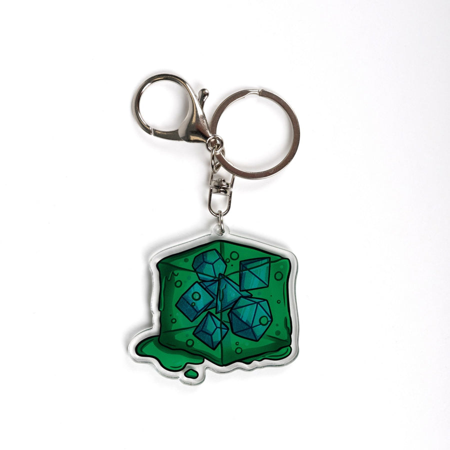  Acrylic keychain of a green gelatinous cube that is oozing and has DND dice inside of it. 
