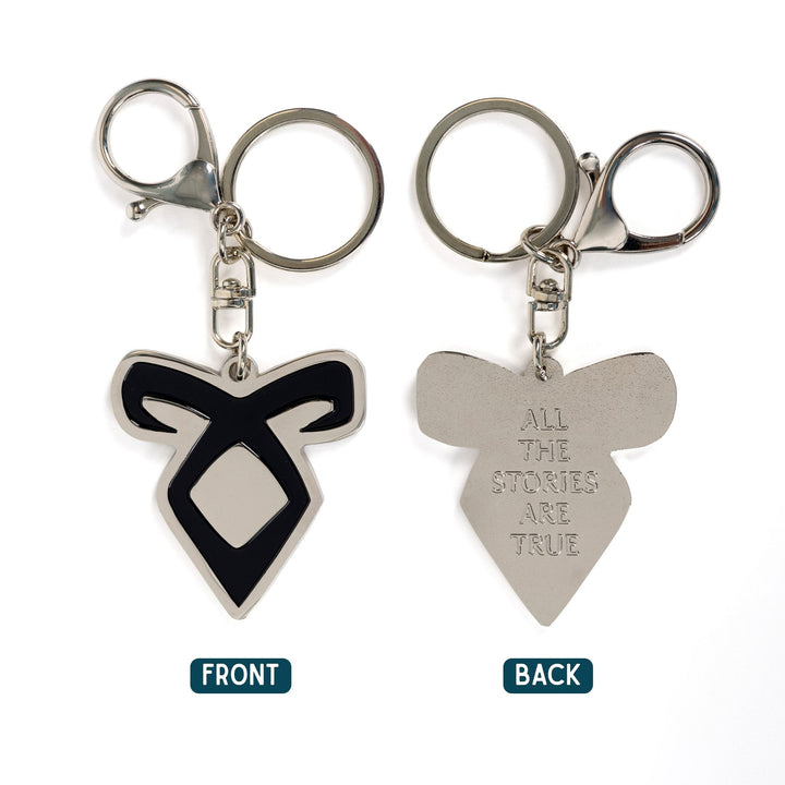 Two silver keychains of an Enkeli rune from Shadowhunters, one side reads ‘All the stories are true.’