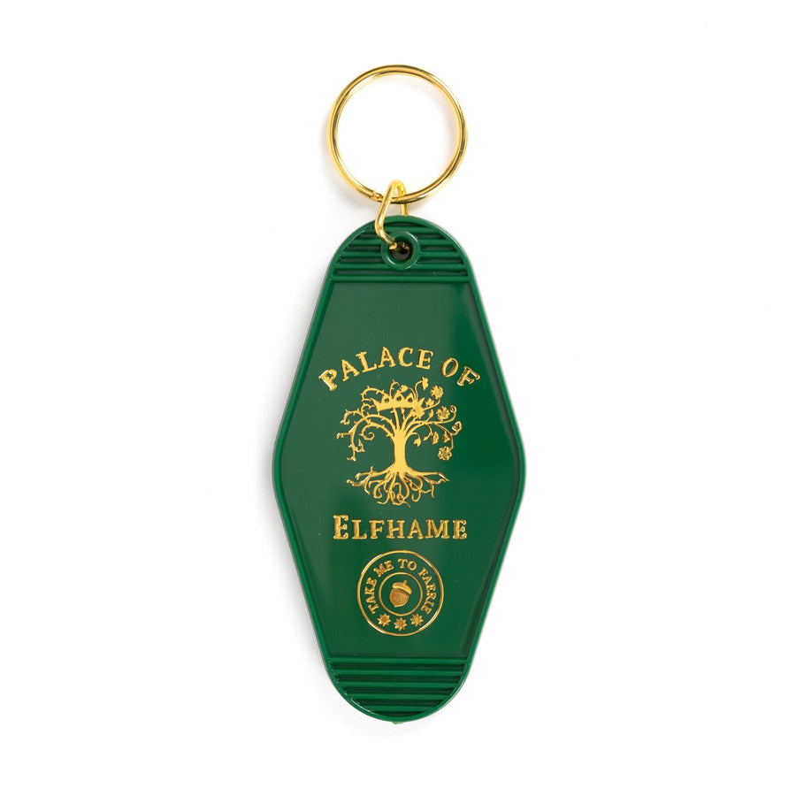 Green motel-style keychain with gold lettering that reads ‘Place of Elfhame.’ and a golden tree. From The Cruel Prince. 
