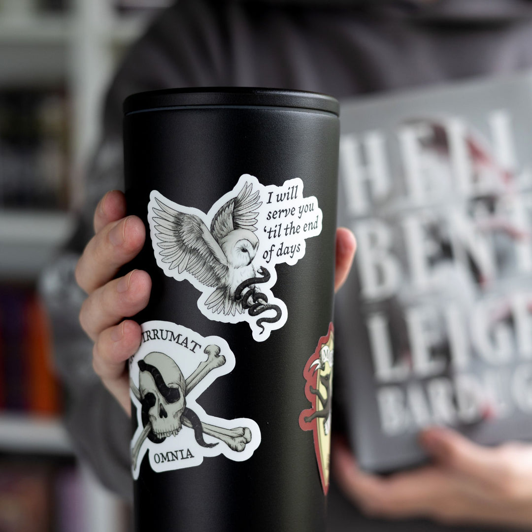 Sticker of owl grabbing a snake that reads ‘I will serve you ‘til the end of days’ on a black tumbler.