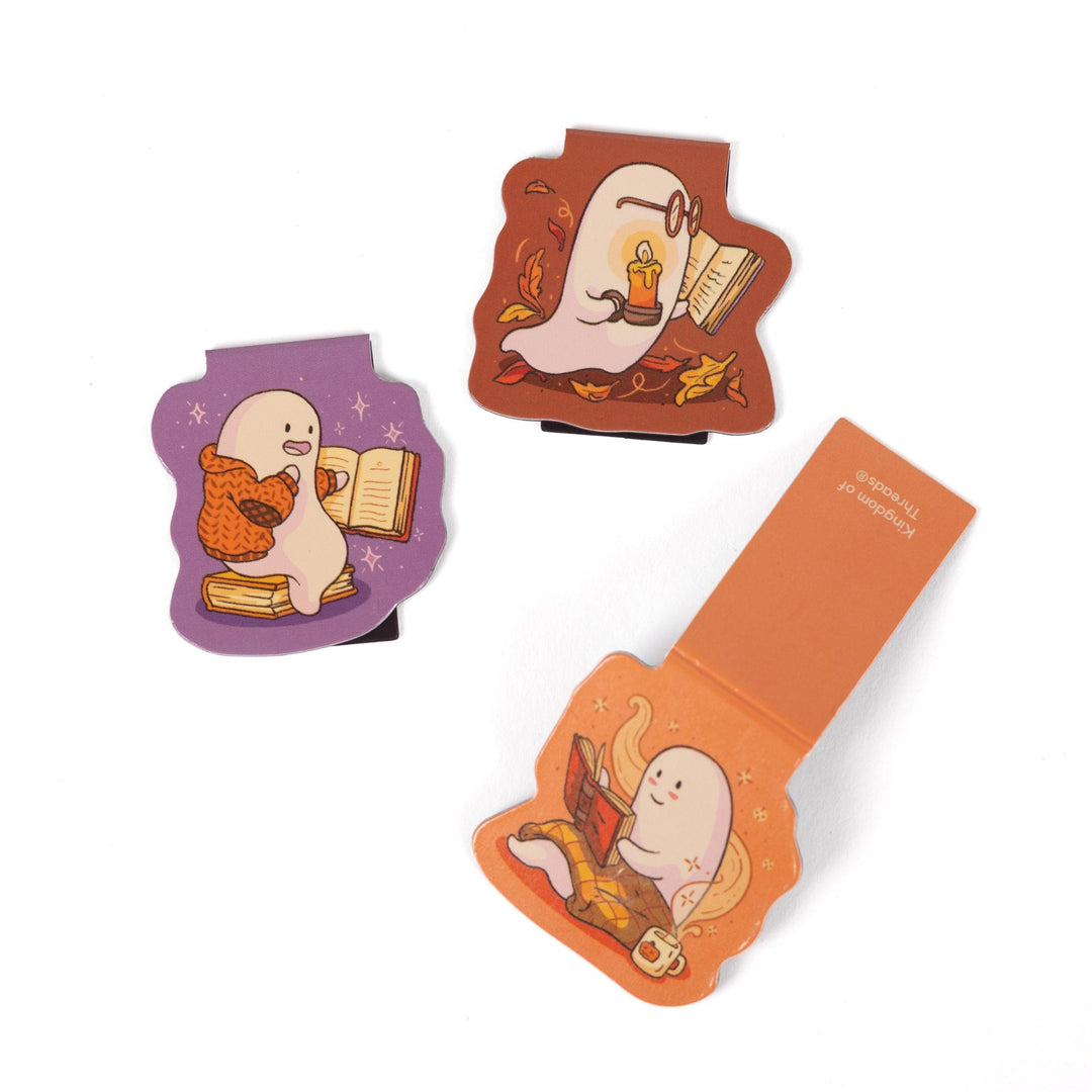Set of 3 magnetic bookmarks, each with a ghost reading a book. One bookmark is open to show its back.