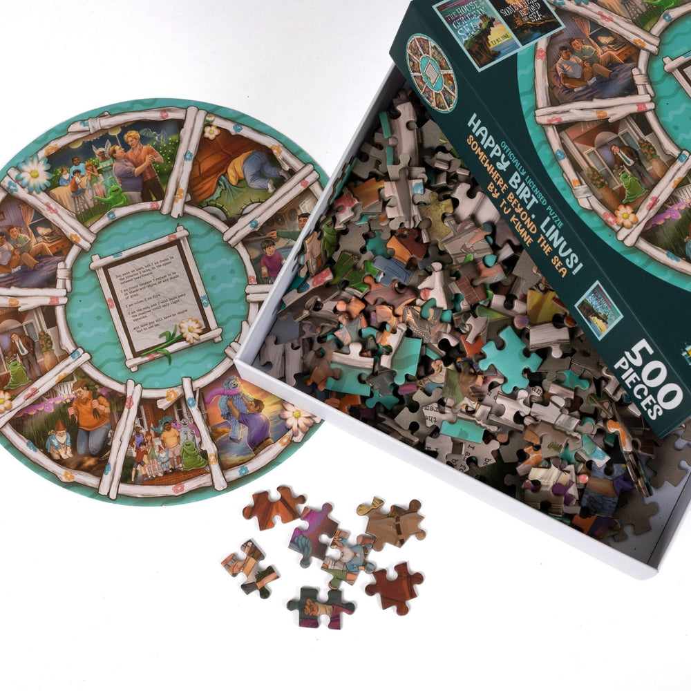 An open box reveals puzzle pieces. A circular art print of the family portraits from House in the Cerulean Sea.