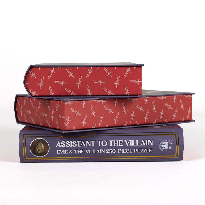 Stack of 3 puzzle boxes showing all sides. Red edges with white swords and the spine of the box reads Assistant to the Villain Evie and The Villain 250-piece puzzle