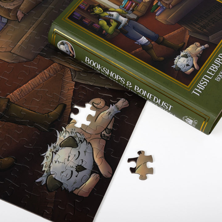 Close up of completed puzzle of Viv in the bookshop from Bookshops & Bonedust with one piece missing.