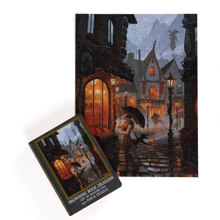 Full completed puzzle of rainy day street scene outside a bookstore and a black, book-shaped box  with matching art for Browing Book Dragons 250-piece puzzle.
