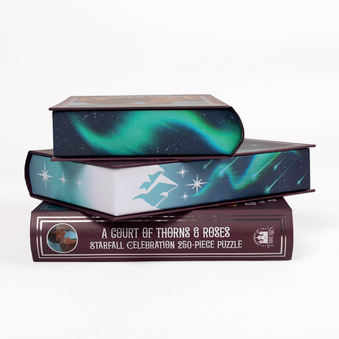 tack of 3 puzzle boxes showing all sides. Edges show Velaris under shooting stars and the spine of the box reads A Court of Thorns and Roses Starfall Celebration 250-piece puzzle.