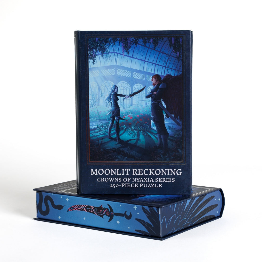 Book-shaped black box for Moonlit Reckoning Crowns of Nyaxia 250-piece puzzle. Art on the front is of Oraya and Raihn.
