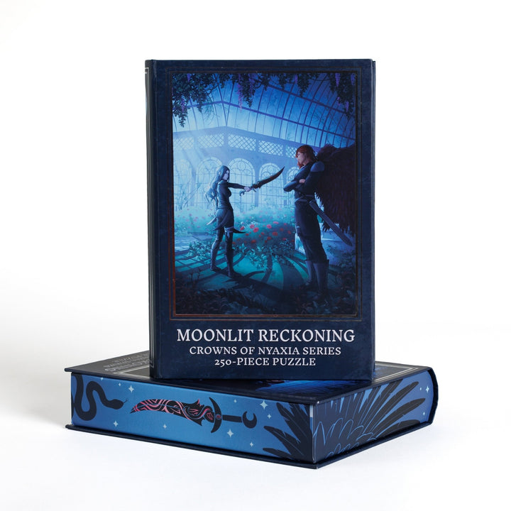 Book-shaped black box for Moonlit Reckoning Crowns of Nyaxia 250-piece puzzle. Art on the front is of Oraya and Raihn.