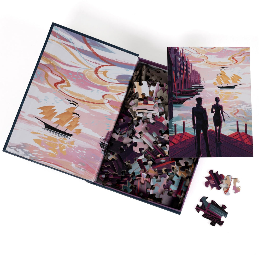 An open book-shaped box reveals puzzle pieces. Inner art on the top flap harbor with ships. An art print of Kaz and Inej on the Ketterdam docks atop the pieces.